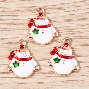 Detail view of snowman alloy pendants with red hats and gold edges for DIY jewelry making