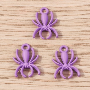 Macro shot of purple spider charms with alloy enamel finish for DIY jewelry crafting