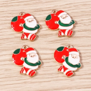 Detail view of four Santa Claus alloy charms with colorful enamel finish for DIY jewelry