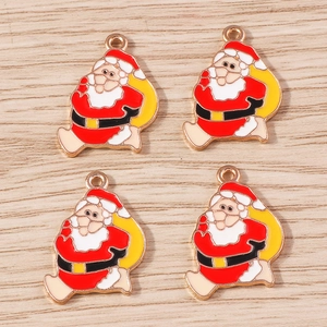 Detail of Santa Claus enamel pendants with gold metal base for DIY holiday jewelry making