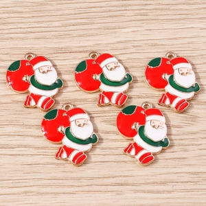 Close-up of five colorful Santa Claus alloy pendants with gold plating for DIY jewelry