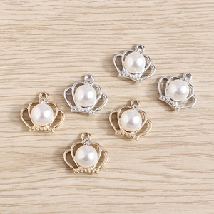 Macro detail of crown shaped pearl pendants with gold and silver frames for DIY jewelry