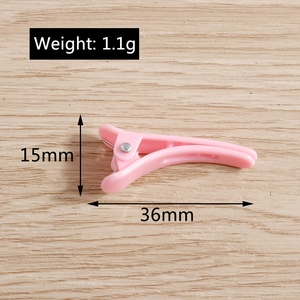 Pink duckbill hair clip detailed view showing 36mm length and 1.1g lightweight design
