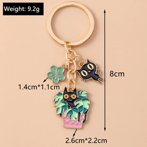 Detailed view of enamel cat and plant keychain charms with precise size measurements