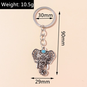 Detail showing vintage silver elephant keychain with turquoise inlay and size dimensions