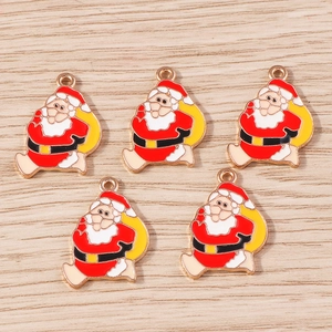 Detail of five Santa Claus enamel charms with gold metal edges for DIY Christmas jewelry