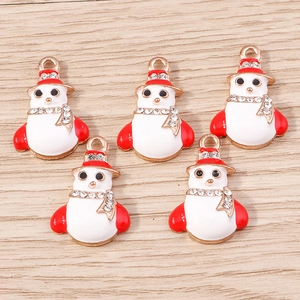 Close-up of five snowman charms with red and white enamel and rhinestones for DIY jewelry