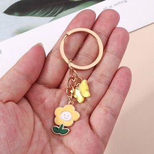 Golden sunflower keychain with yellow smiley face flower and butterfly pendant