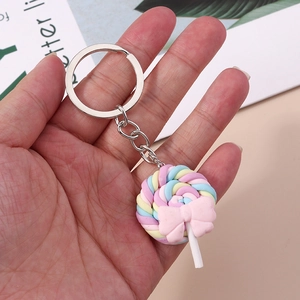 Detail of macaron spiral lollipop keychain with pink bow and silver metal clasp