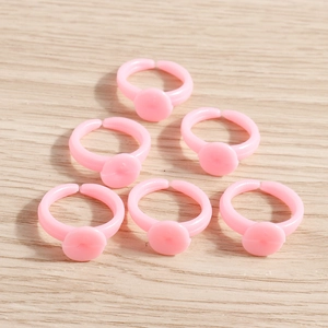 Pink adjustable plastic ring bases with flat circular discs for DIY jewelry crafting