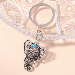 Vintage elephant head keychain with turquoise stone and silver engraved filigree design