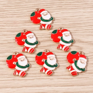 Detailed macro view of 6 enamel Santa Claus alloy pendants for DIY jewelry making crafts