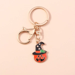 Detail of Halloween pumpkin keychain with a black witch hat and golden lobster clasp