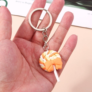 Detail of colorful spiral lollipop keychain with orange bow and silver metal ring