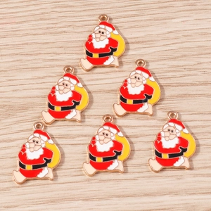 Detailed view of six Santa Claus alloy enamel pendants with golden loops on wood background