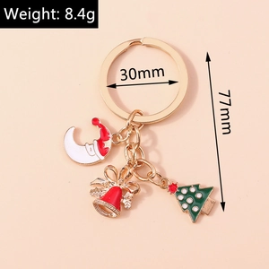 Vue détaillée d'un porte-clés de Noël avec charms lune, cloche et sapin, poids 8.4g