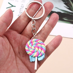 Pink and blue spiral lollipop keychain with a silver ring on a white card background