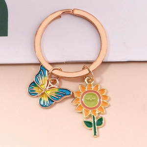 Close-up of rose gold keychain with colorful butterfly and sunflower charms