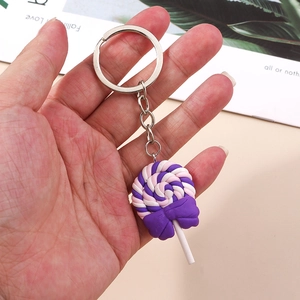 Lollipop keychain with purple and pink swirl design and a decorative purple bow