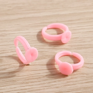 Three adjustable pink plastic ring bases with flat trays for DIY jewelry making