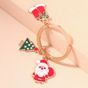 Porte-clés de Noël créatif avec Père Noël, sapin et clochette rouge sur des supports