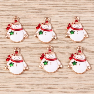 Enamel snowman Christmas pendants set of six with red scarves on wooden surface