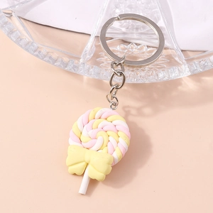 Detail of pink and yellow lollipop keychain with a cute bow and silver metal ring