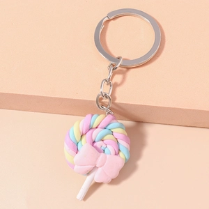 Close-up of macaron-colored lollipop keychain with pink bow and silver metal chain