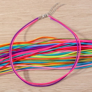 Close-up of colorful waxed cord necklaces with silver lobster clasps and extension chains