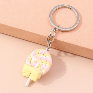 Detailed view of 3D spiral lollipop keychain with pink and yellow tones and a bow