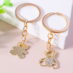 Golden bear keychain set with rhinestone hollow design and heart pattern engraving