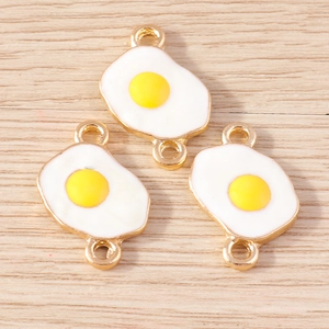 Close-up of three cute enamel fried egg alloy pendants with golden double loops