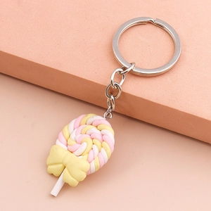 Macro shot of pink and yellow swirl lollipop keychain with a yellow bow decoration