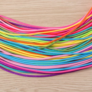 Close-up of assorted colorful waxed cords with fine woven texture for DIY jewelry making