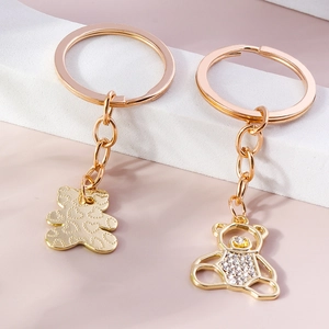 Golden cartoon bear keychains with rhinestone embellishments and hollow heart textures