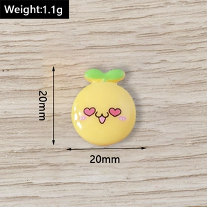 Macro detail of a 20mm yellow cartoon resin fruit pendant with cute facial expression