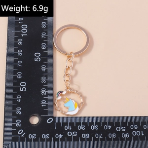 Detail view of unicorn rainbow keychain with light blue enamel and 6.9g weight scale