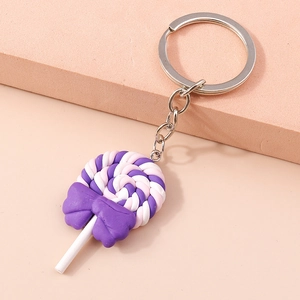 Detailed view of spiral swirl lollipop keychain with purple bow and metal chain