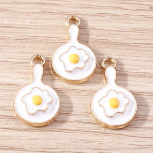 Macro view of cute fried egg enamel alloy pendants for DIY jewelry making
