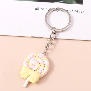 Detail of pink and yellow lollipop keychain with a cute yellow bow and silver metal ring