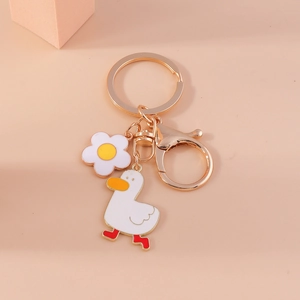 Creative cartoon duck keychain with white flower pendant on a golden lobster clasp