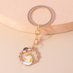 Cartoon unicorn keychain with stars and rainbow charms on a golden metal ring