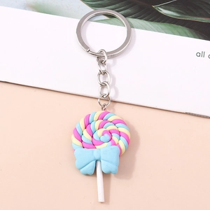 Detailed macro view of a colorful spiral resin lollipop keychain with a blue bow decoration