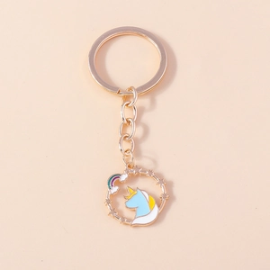 Detailed close-up of a golden unicorn keychain with rainbow and star enamel charms