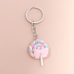 Close-up of a colorful macaron swirl lollipop keychain with a pink bow and silver ring