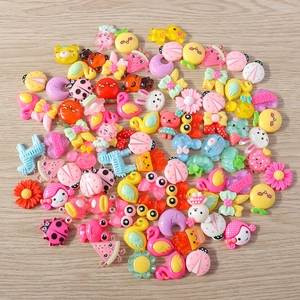 Macro view of assorted resin animal and flower pendants for DIY jewelry making