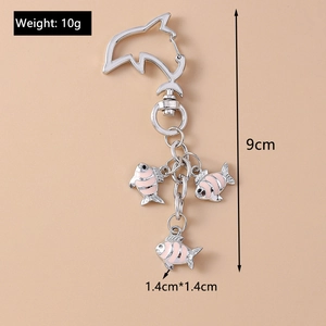 Macro view of ocean dolphin clasp keychain with pink striped enamel fish charms