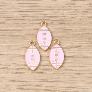 Detail showing pink enamel rugby ball charms with gold plated finish for DIY jewelry