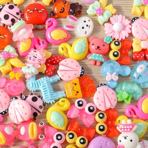 Detailed view of colorful resin cartoon animals and flower charms for DIY crafts