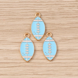 Three light blue enamel rugby pendants with alloy gold trim on a wooden background